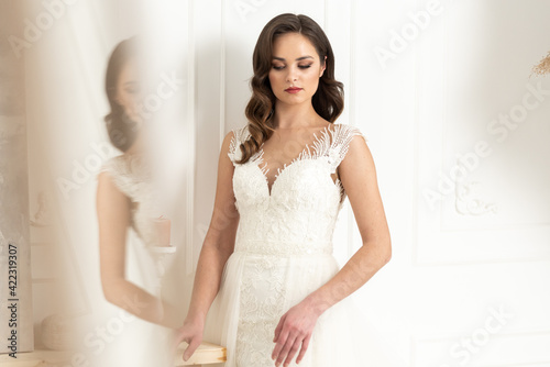 Fashion beautiful woman with make up and hair style in wedding dress. Morning bride