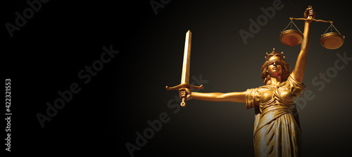 Goddess Themis of justice with a sword. photo