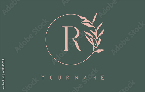 R Letter logo design with dust pink circle and leaves on a green background. Initial Letter R Vector Illustration with Botanical elements.