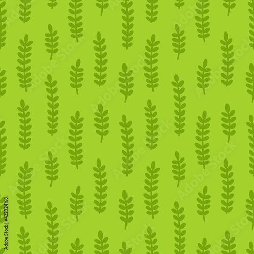 Vector seamless pattern with green branches on light green background.