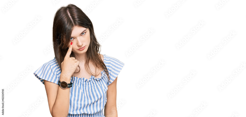 Young beautiful caucasian girl wearing casual clothes pointing to the eye watching you gesture, suspicious expression