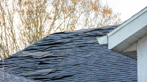 old asphalt roof shingles on house roof