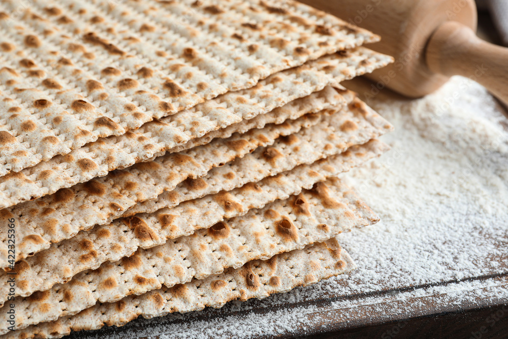 Stack of matzos on wooden board, closeup Stack of matzos on wooden board, closeup