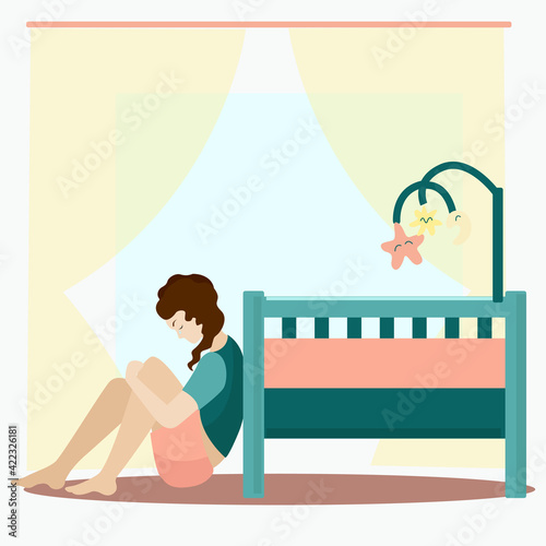A woman sits near the crib and cries