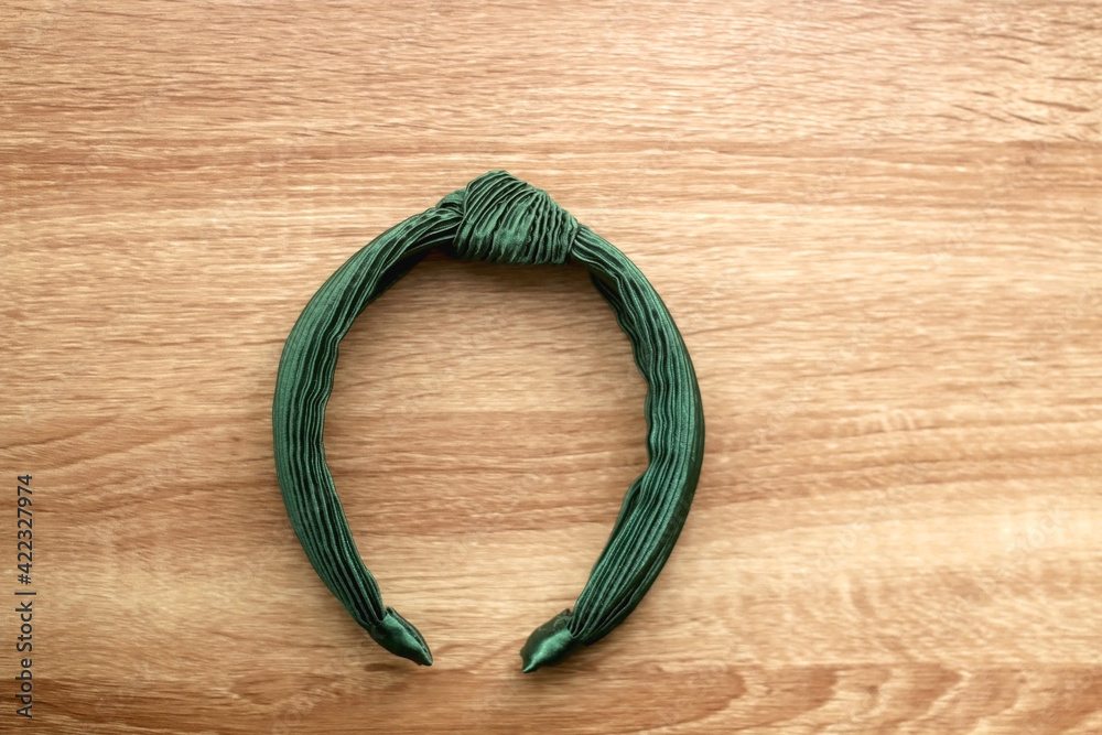 Green headband on wooden background. Flat lay. Green headband on wooden background. Flat lay.