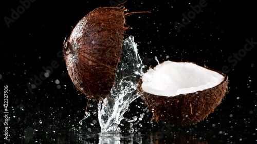 Super slow motion of falling cracked coconut photo