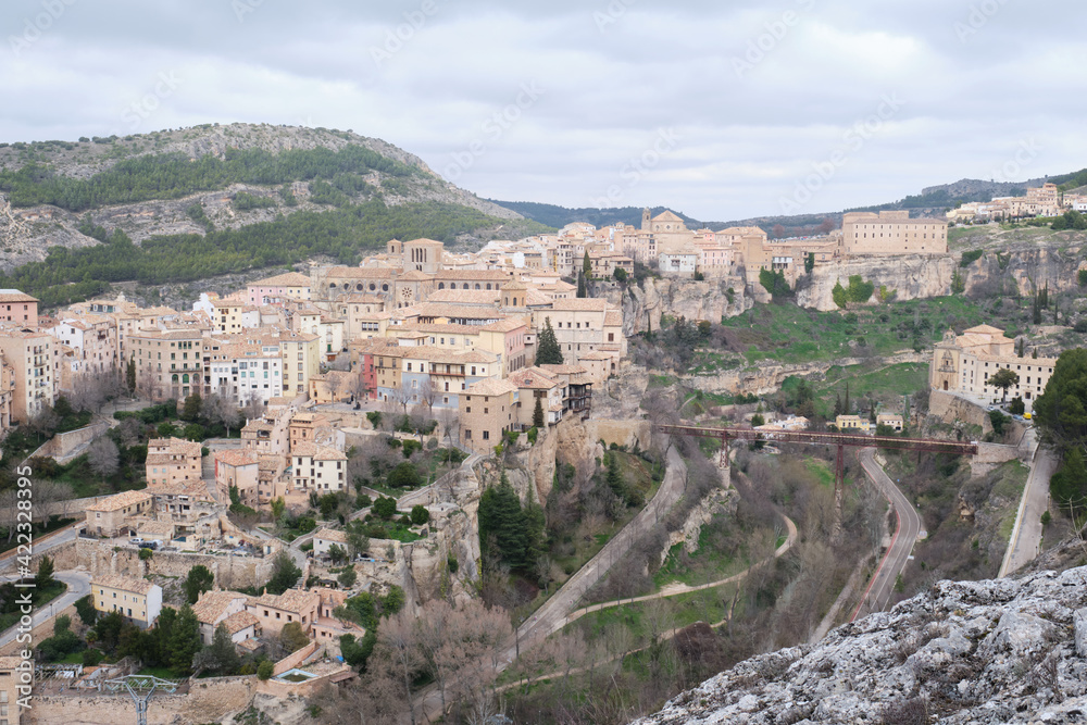 View of Hanged Houses (Casas Colgadas) and San Pablo bridge in Cuenca (Spain) taking from a hill.
