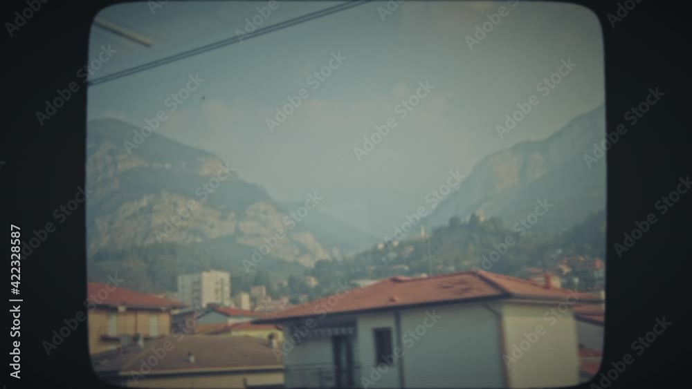 Passing a medieval Italian town surrounded by mountains, on train. Vintage Film Look. Passing a medieval Italian town surrounded by mountains, on train. Vintage Film Look.