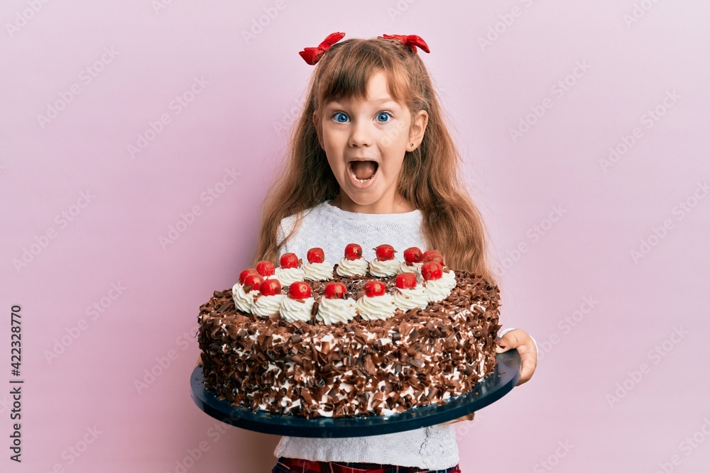 Little caucasian girl kid celebrating birthday holding big chocolate ...