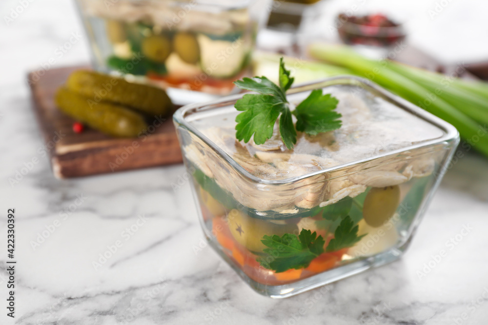 Delicious aspic with meat and vegetables served on white marble table Delicious aspic with meat and vegetables served on white marble table