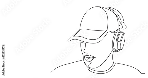 continuous line drawing of young man in hat listening music in headphones