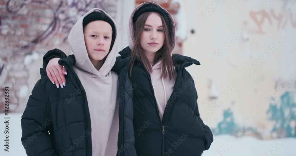 Teens portrait. Outdoor winter street portrait of two teens- girl and boy Teens portrait. Outdoor winter street portrait of two teens- girl and boy
