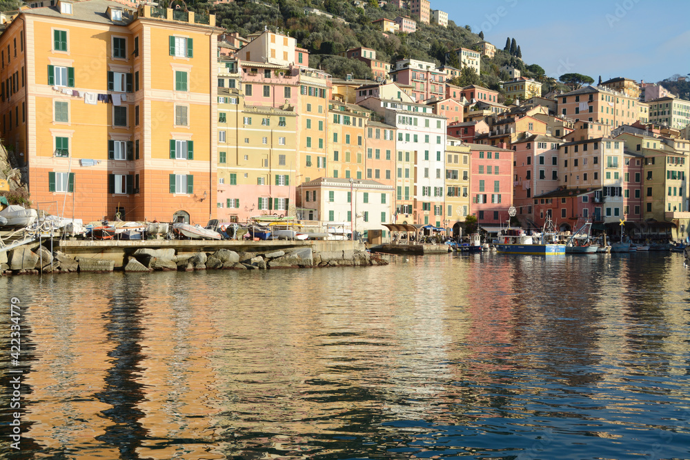 Camogli is a typical seaside village and tourist center known for its marina, church and tall colorful buildings on the seafront.