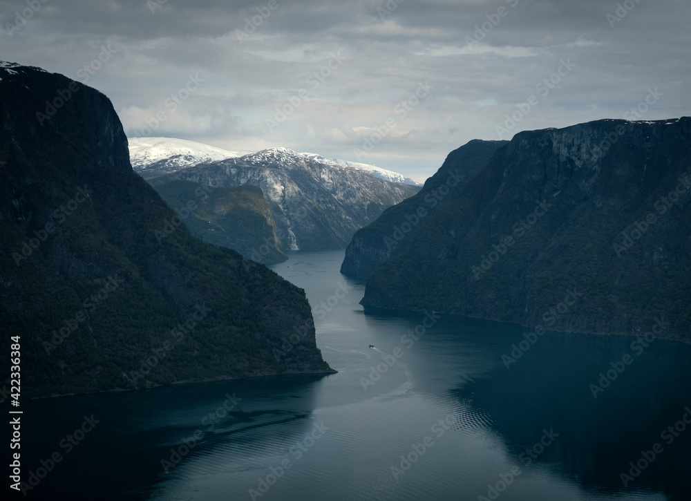 Aurland Fjord from Stegastein viewpoint in spring in Norway on a boat on the water and snow mountains Aurland Fjord from Stegastein viewpoint in spring in Norway on a boat on the water and snow mountains