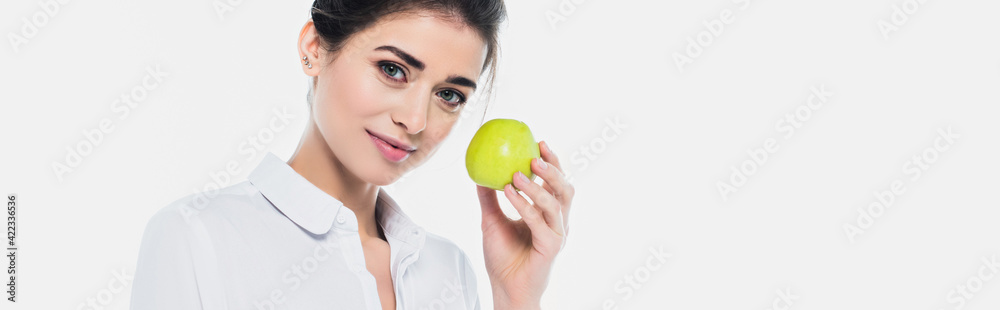 Pretty woman in shirt holding green apple isolated on white, banner Pretty woman in shirt holding green apple isolated on white, banner