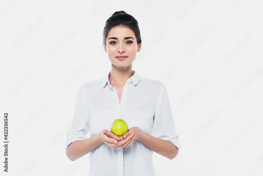 Young woman in shirt holding fresh green apple isolated on white Young woman in shirt holding fresh green apple isolated on white