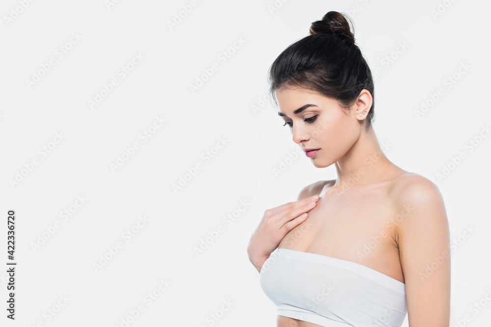 Brunette woman in white bra looking away isolated on white Brunette woman in white bra looking away isolated on white