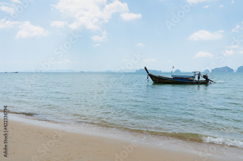 landscape of long tail boat on the blue sea with white sand in summer