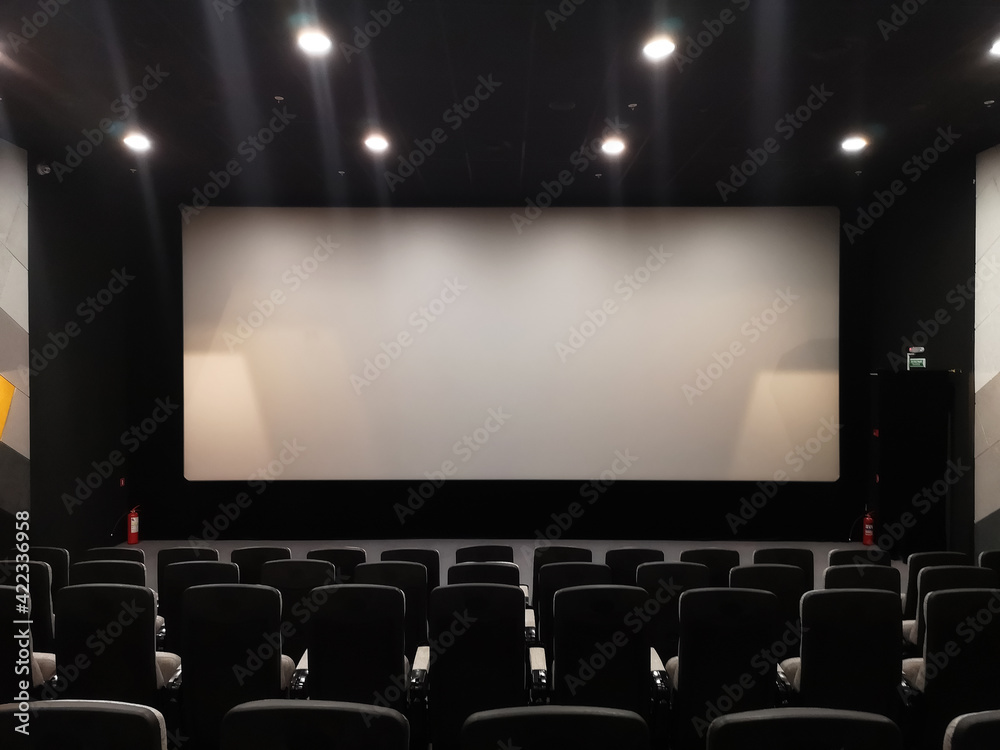 Cinema screen and empty chairs. Absence of visitors during coronavirus pandemic