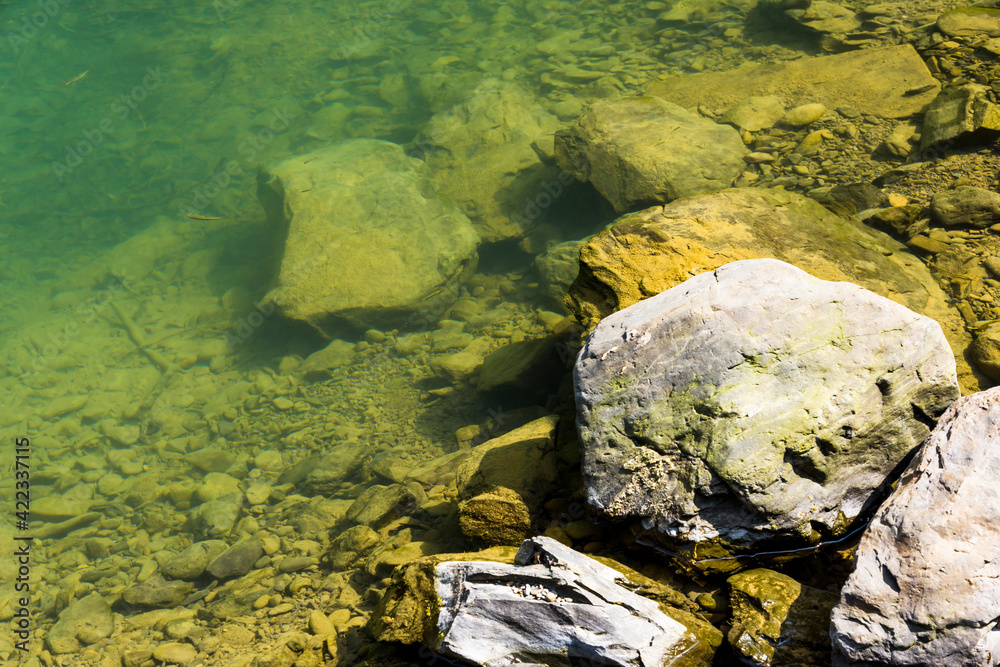 The stones under the pond, close-up as a background.