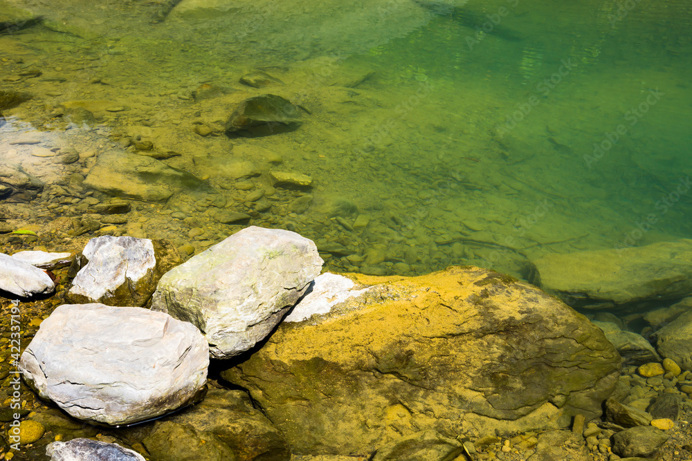 The stones under the pond, close-up as a background. The stones under the pond, close-up as a background.
