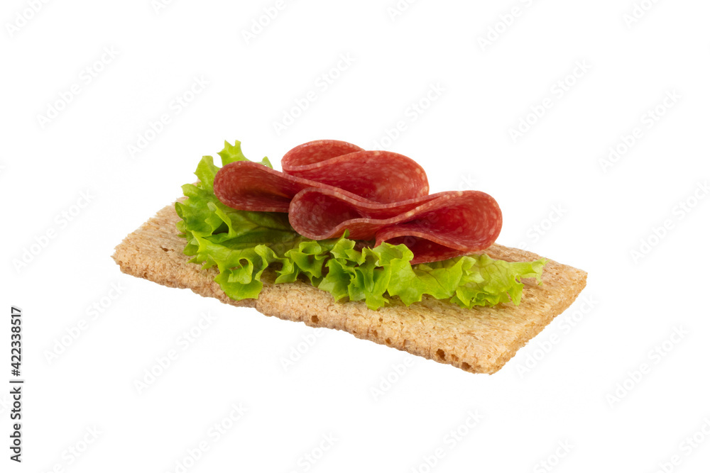 Variety of mini sandwiches with cream cheese, vegetables and salami.