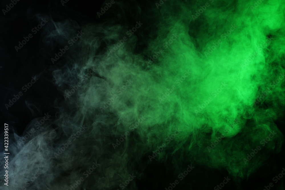 Smoke in red-green light on black background