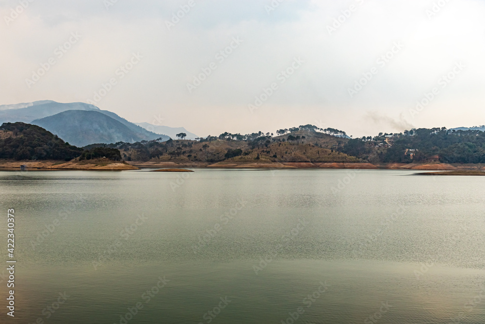 lake calm water with mountain background at day from flat angle