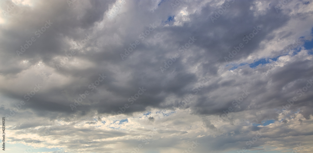 dramatic blue sky with rays and white clouds