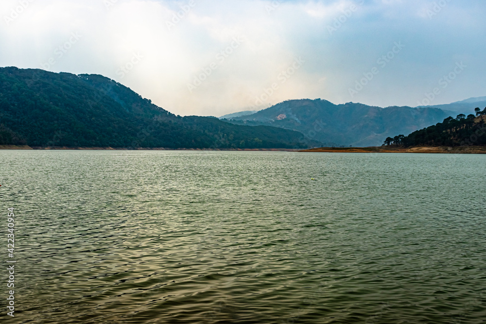 lake calm water with mountain background at day from flat angle