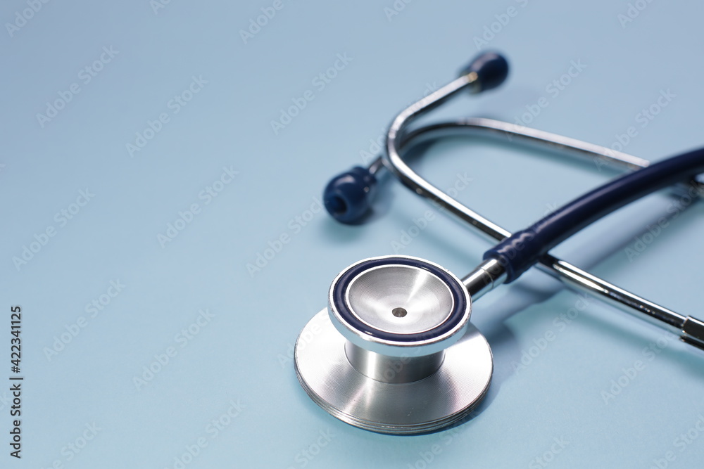 Blue medical stethoscope on blue background. Close-up Blue medical stethoscope on blue background. Close-up