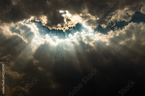 sun rays through cloud patch at day dramatic scene