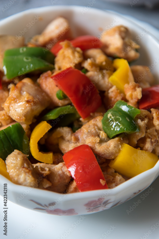 Chicken pieces and bell peppers in a bowl with use of selective focus. Chicken pieces and bell peppers in a bowl with use of selective focus.