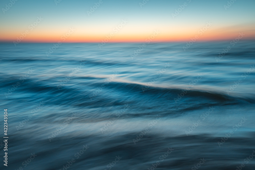 Sea at sunset with intentional camera movement, motion blur