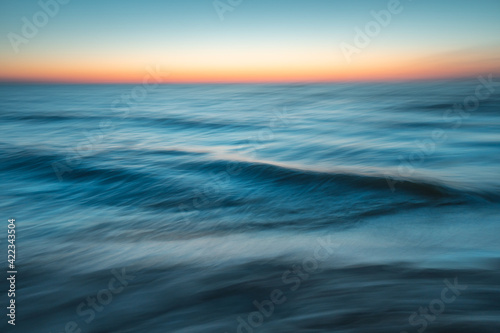 Sea at sunset with intentional camera movement  motion blur