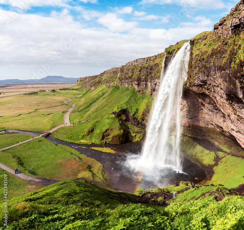 Charming beautiful waterfall Seljalandsfoss in Iceland. Exotic countries. Amazing places. Popular tourist atraction.