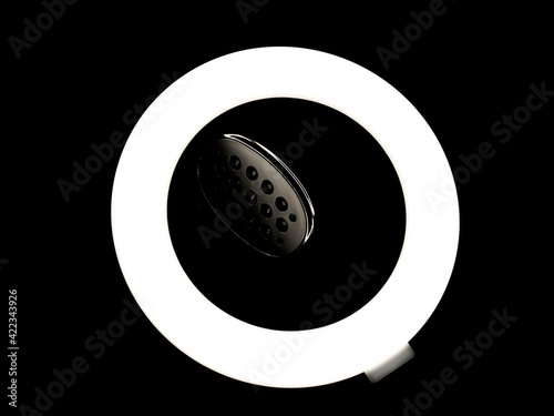 Ring light and LED lamp, on black background. Concept photography