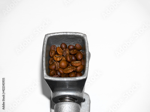 Vintage antique manual coffee grinder with roasted coffee beans, ground coffee on wooden table,top view