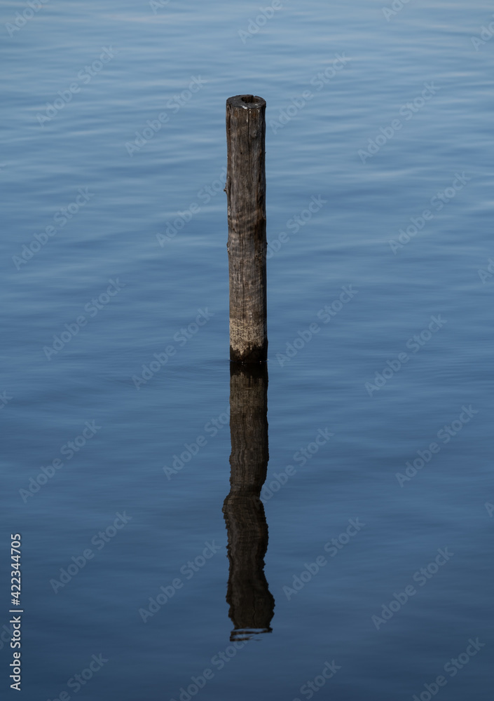 Pole in the blue calm water