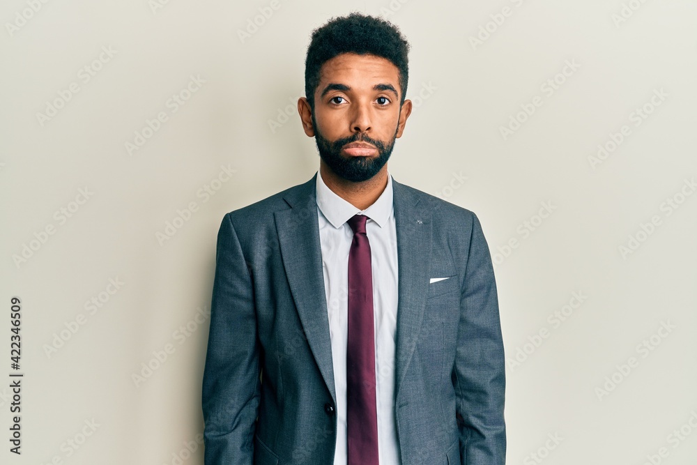 Handsome hispanic man with beard wearing business suit and tie depressed and worry for distress, crying angry and afraid. sad expression. Handsome hispanic man with beard wearing business suit and tie depressed and worry for distress, crying angry and afraid. sad expression.