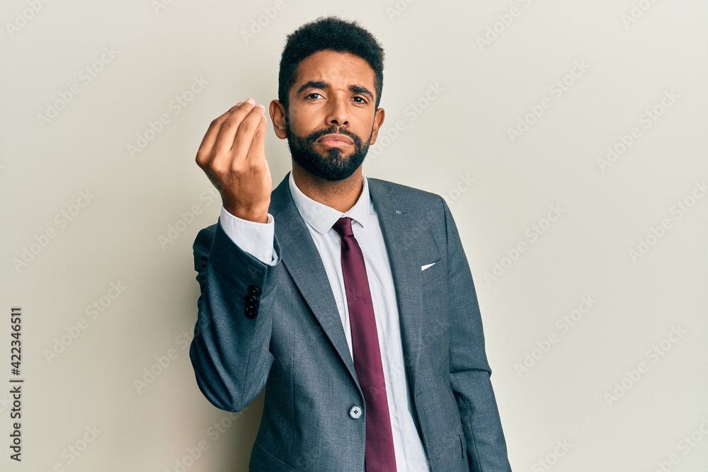 Handsome hispanic man with beard wearing business suit and tie doing italian gesture with hand and fingers confident expression Handsome hispanic man with beard wearing business suit and tie doing italian gesture with hand and fingers confident expression
