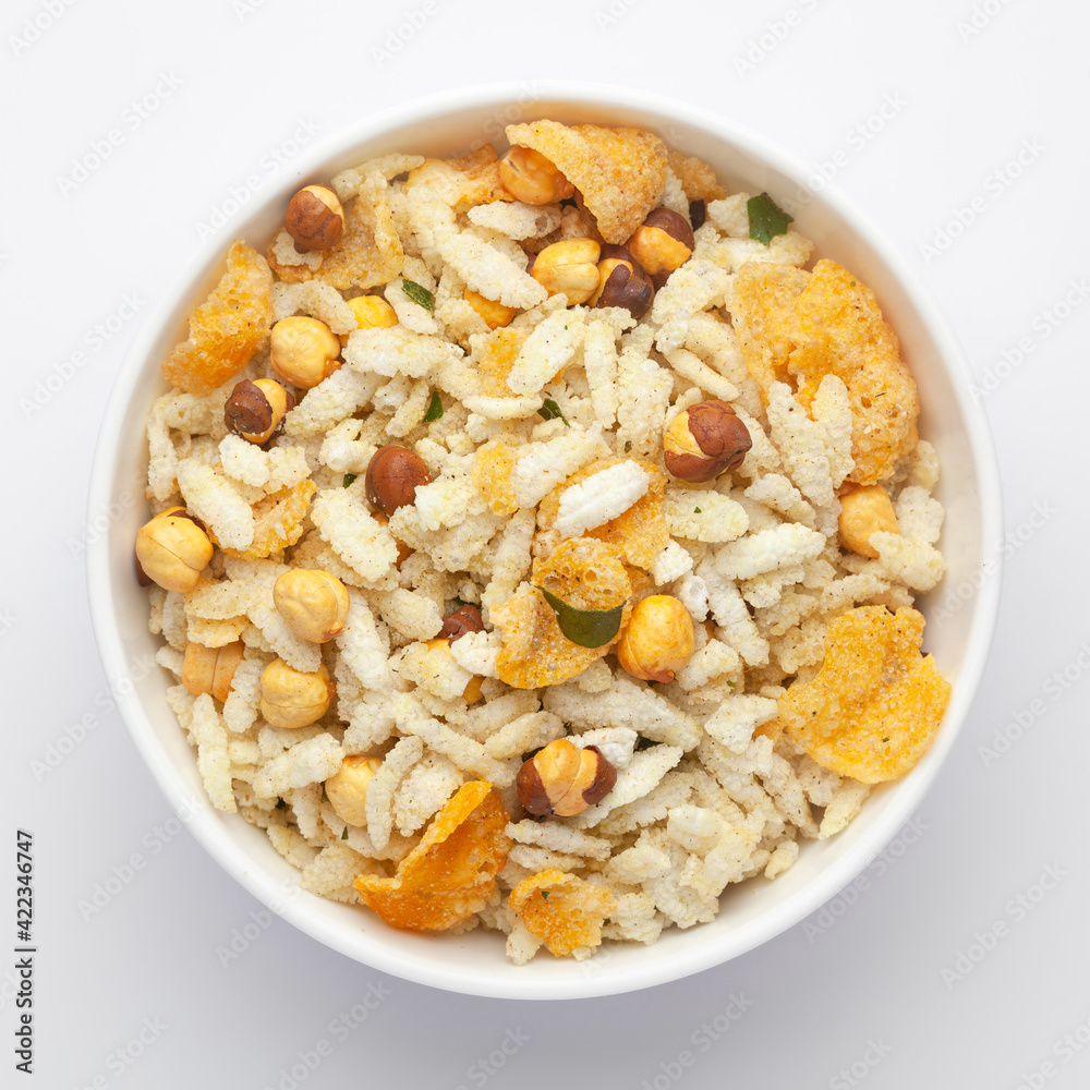 Close-Up of Crunchy Diet Mixture in a white Ceramic bowl made with Puffed Rice, Corn Flakes, and Curry leaves. Indian spicy snacks (Namkeen), Top View Close-Up of Crunchy Diet Mixture in a white Ceramic bowl made with Puffed Rice, Corn Flakes, and Curry leaves. Indian spicy snacks (Namkeen), Top View