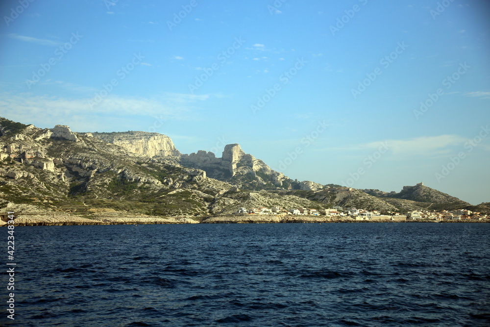 View of the city on the tree-lined and rocky coast, Parc National des Calanques, Marseille, France