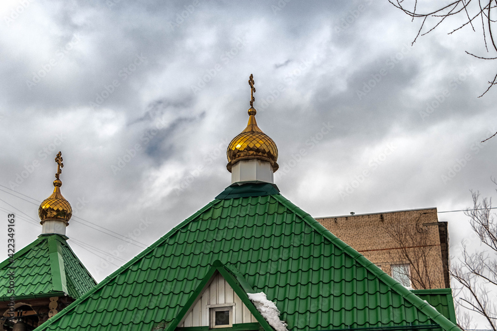 Domes of the Temple in honor of the icon of the Mother of God the Queen against the sky.
