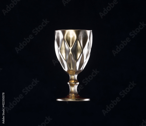 ancient golden wine glass isolated on black background