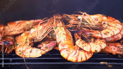 Slider shot of tiger prawns, shrimps grilled on barbecue fire stove