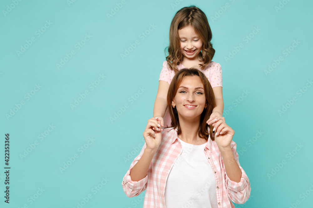 Happy woman in pink clothes have fun with cute child baby girl 5-6 years old Mommy little kid daughter stand behind hug isolated on pastel blue azure background studio Mothers Day love family concept Happy woman in pink clothes have fun with cute child baby girl 5-6 years old Mommy little kid daughter stand behind hug isolated on pastel blue azure background studio Mothers Day love family concept