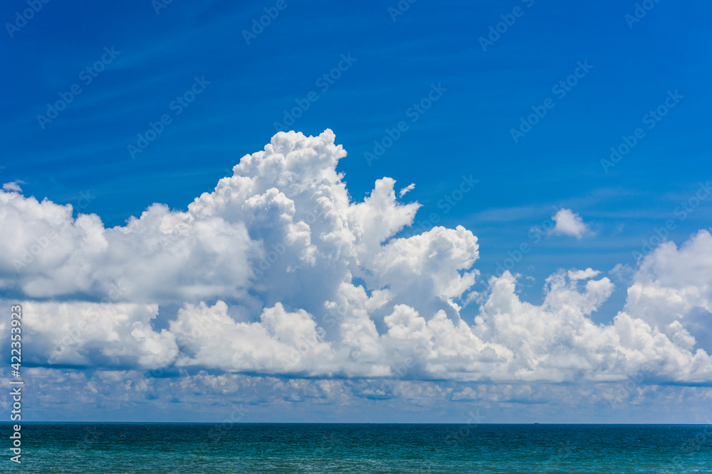 The tropical sea under the blue sky and clouds