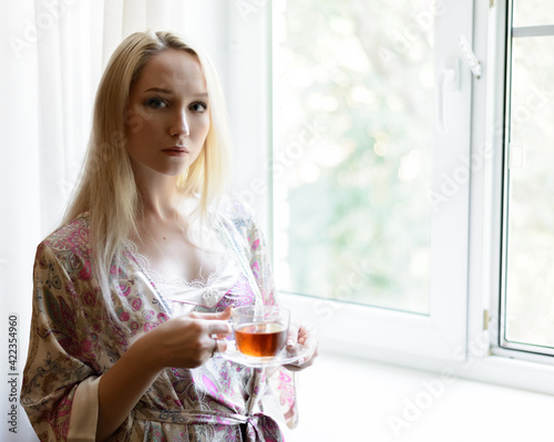 Girl with a cup of tea. Selective focus.