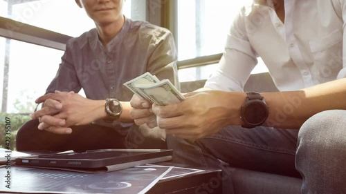 Businessmen are paying compensation to partners. or Businessmen are receiving dividends from investments.